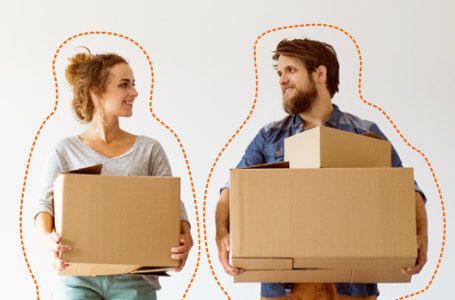 Chico y chica cargados con cajas de cartón